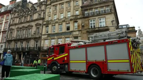 A fire engine is parked near the site of an incident where a car plowed into a crowd of Liverpool fans during a parade celebrating their side's Premier League title