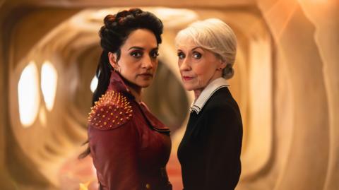 Archie Panjabi and Anita Dobson stood together in costume both playing the Rani