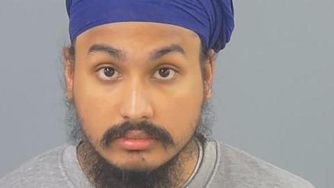Vickrum Digwa, a man with a beard, a grey jumper and a purple turban looking to the camera.