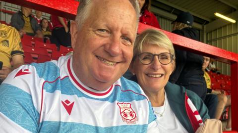 Ian Healy and his wife Helen (right) watch Wrexham in a home game
