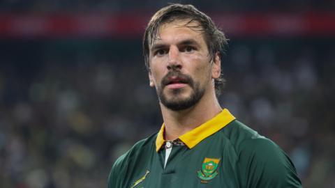 Eben Etzebeth, wearing a green Springboks jersey, looks past the camera during a South Africa rugby game