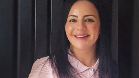 Vikki Soloman. She is wearing a pink top and is smiling at the camera. 