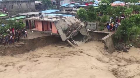 Flood water destroying a house