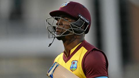 West Indies batter Evin Lewis walks off after being dismissed