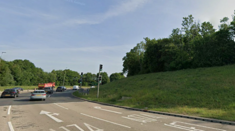 A multi-lane roundabout near the A19 in Thornaby, with road markings and cars travelling away from the camera. There are traffic lights and a large grass bank in the centre of the roundabout. 