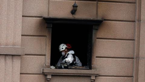 A joint investigation team examines the site of a fire at a hotel in Bucheon,