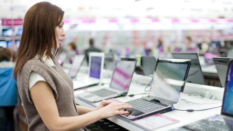 Stock image of a woman buying a laptop