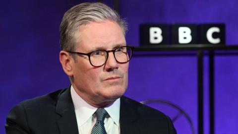 Sir Keir Starmer sitting in a TV studio with a BBC logo over behind him in 2024