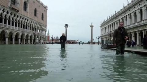 People walking through Venice floods