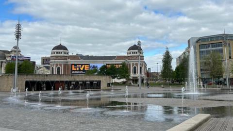 Fountains on a paved square, with the Bradford Live entertainment venue in the background.