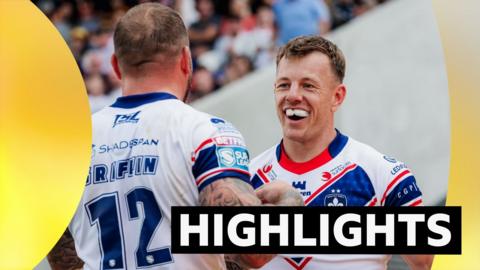 Tom Johnstone of Wakefield celebrates with Josh Griffin after scoring a try