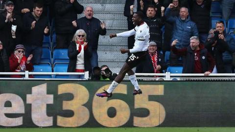 Daniel Kanu celebrates scoring for Walsall