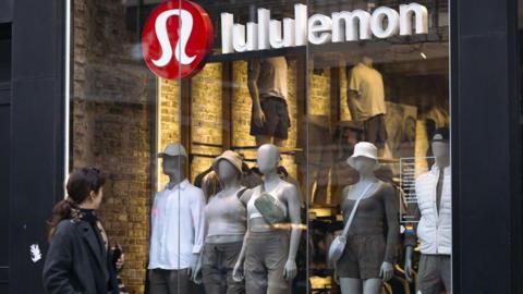 A woman looks at a Lululemon store in New York