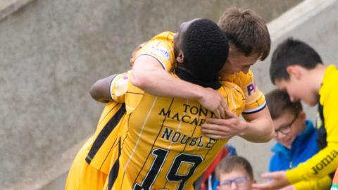 James Penrice is embraced by Joel Nouble