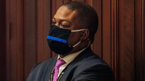 Capitol Police Officer Eugene Goodman watches newly released video footage, of the 6 January attack during Donald Trump's impeachment trial