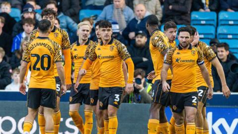 Hull players celebrate a goal during their win at Millwall