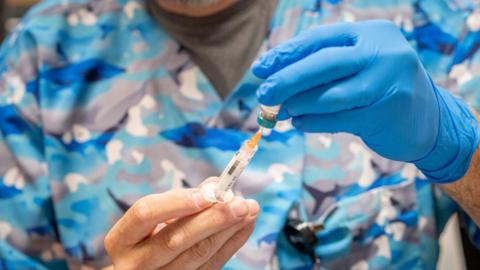 A doctor in Texas holds a measles vaccine