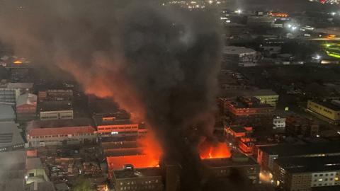 Smoke rises from a burning building amid a deadly fire, in Johannesburg, South Africa, August 31, 2023