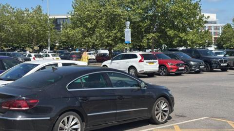 Several cars parked in a parking lot in Doncaster on a sunny day