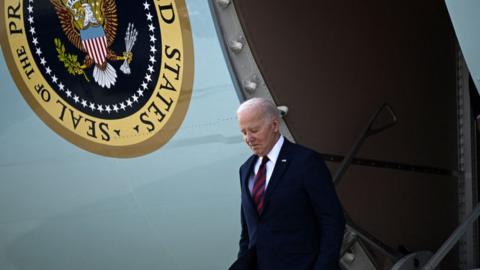 US President Joe Biden steps off Air Force One upon arrival at Milwaukee International Airport Air National Guard Base in Milwaukee, Wisconsin, on March 13,