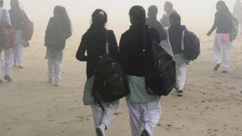 Indian schoolgirls walk to school after three days off due to heavy smog in Amritsar