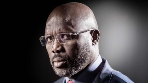 This file photograph taken on September 25, 2017, shows former football player and candidate in Liberia"s presidential elections, George Weah poses during a photo session in Paris.