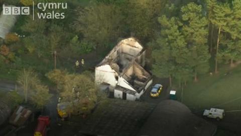 The burnt out shell of the house in Powys