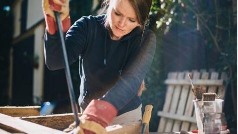 Woman doing DIY in backyard