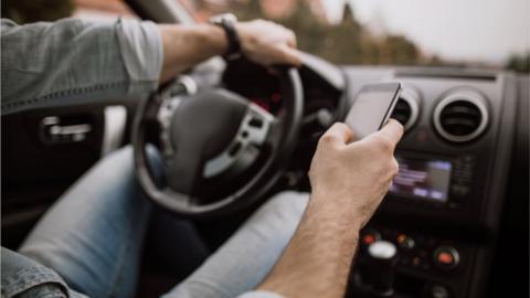 Someone driving while using the phone