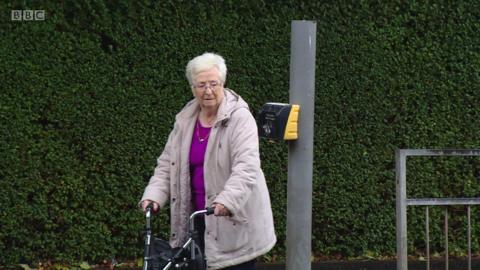 Elderly lady crossing the road
