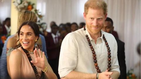 The Duke and Duchess of Sussex greeting people at the Lightway Academy in Abuja