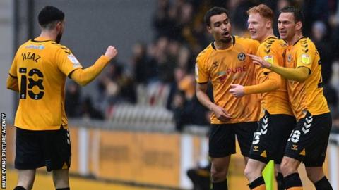 Newport players celebrate Ryan Haynes' opening goal