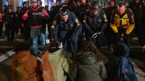 Police move in to arrest a group of pro-Palestinian demonstrators in Boston
