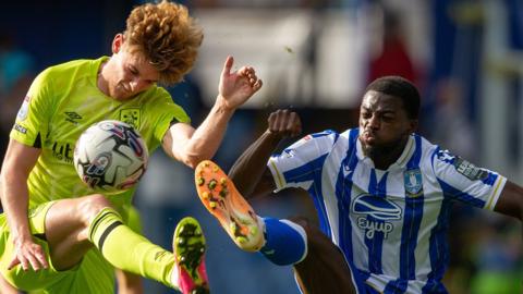 Sheffield Wednesday and Huddersfield scrap for the ball in midfield