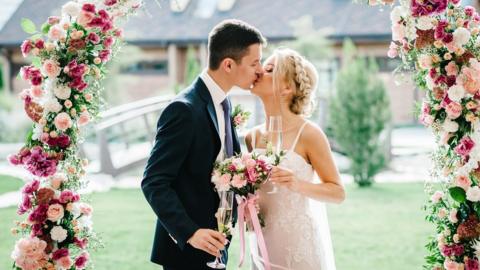 Couple getting married under an arch