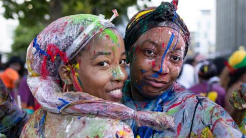 Revellers covered in paint as the opening of the Notting Hill carnival begins