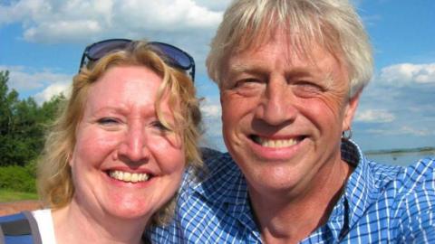 Sarah Packwood on the right, and her husband Brett Clibbery smile at the camera for a selfie