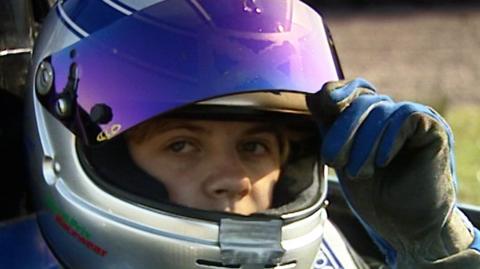 Close up of racing driver Susie Stoddart wearing a crash helmet in her F4 car.