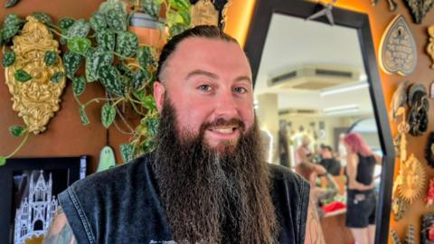 Simon Tuckwell - the self-styled Heavy Metal Hairdresser - in front of a mirror at his Nottingham City Centre salon.
