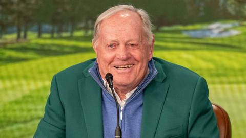 Jack Nicklaus speaking at a press conference in a green jacket