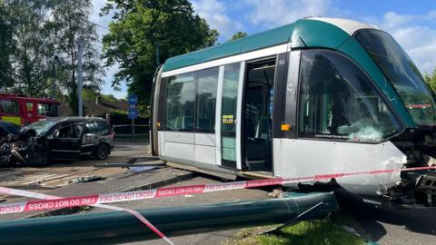 A damaged car and tram at Queen's Walk in Nottingham