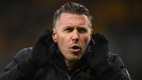 Rob Edwards gestures to the Molineux crowd during a Wolves game