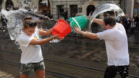 People throwing water on each other