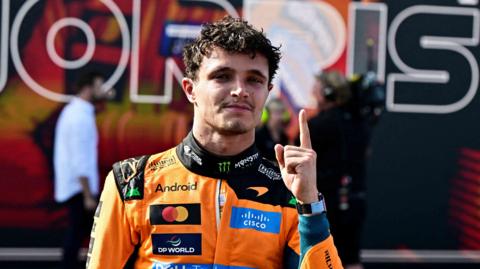 McLaren's Lando Norris holds up his left index finger in celebration after winning the Hungarian Grand Prix
