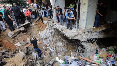 People check the damage following an Israeli strike in Beirut's southern suburbs on September 20, 2024.