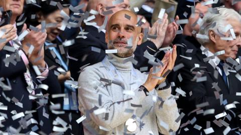 Pep Guardiola waits for the FA Cup trophy lift