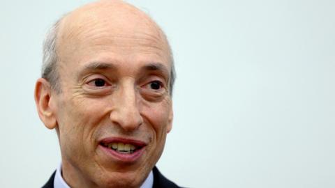 Headshot of Gary Gensler who is smiling and wearing a suit