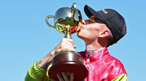 Robbie Dolan kisses the Melbourne Cup trophy