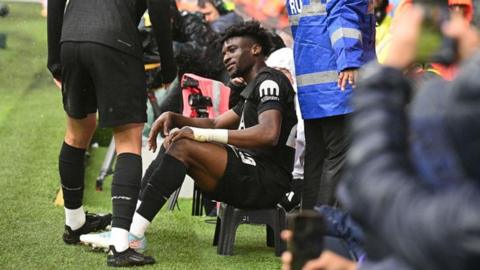 Tottenham's Mohammed Kudus celebrates by sitting on a stool after scoring against Leeds United