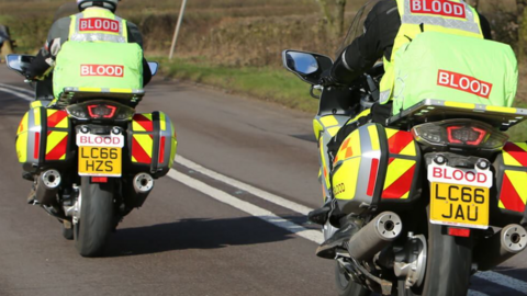 Two blood bikes being ridden on a road